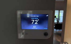 A smart thermostat displaying cooling status and room temperature, installed by Kustom Heating & Cooling in Elgin, IL