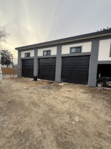 Three newly installed black commercial rolling doors by Universal Overhead And Garage Doors in Baltimore, MD.