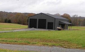 Three black garage doors installed on a grey metal building by Affordable Overhead Garage Door in Modesto, CA