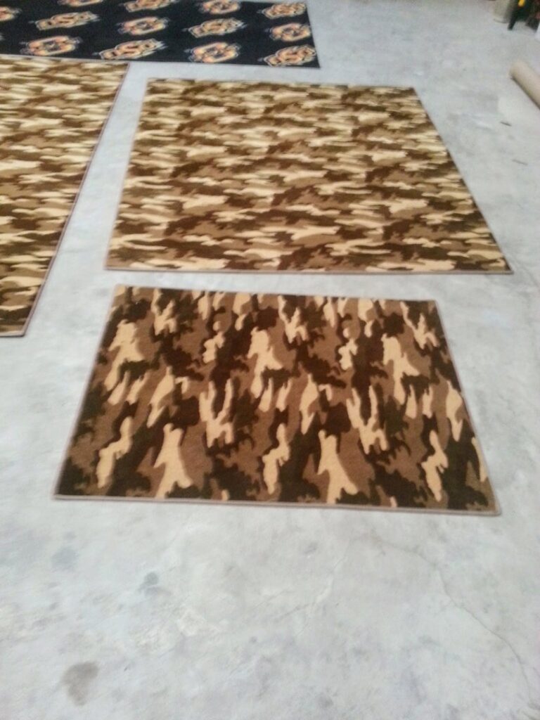 Three rectangular camouflage pattern rugs with bound edges, custom-made by Carpet Binding By Scott in Oklahoma City, OK