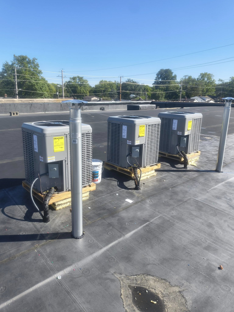Three commercial AC condenser units installed on a rooftop by Aaron's Affordable Ac in Indianapolis, IN.