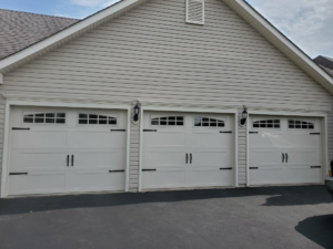 Three decorative white residential garage doors with windows and hardware, installed by Midland Glass and Garage Doors in Frederick, MD