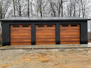 Three modern wood-look garage doors with horizontal panels and windows installed by Affordable Overhead Garage Door in Modesto, CA