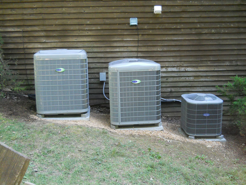 Three outdoor AC units installed side-by-side against a building wall by MMI Climate Solutions in Lexington, KY.