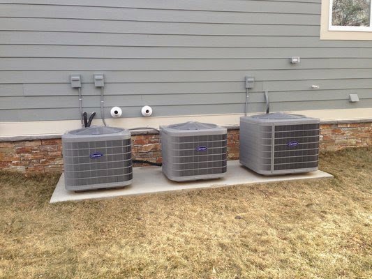 Three outdoor air conditioning units installed side-by-side on a concrete pad by 495 HVAC in Annandale, VA.