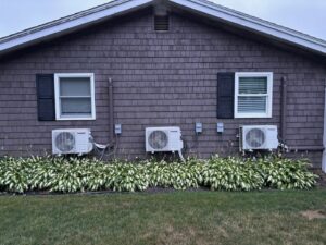 Three outdoor mini-split HVAC condenser units professionally installed by A&A Mechanical HVAC in Raynham, MA.