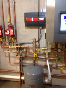 Three tankless water heaters professionally installed on a wall by Green Planet Solutions Corporation in Moscow, PA.