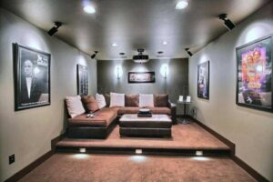 A tiered home theater room featuring brown wall-to-wall carpet installed by Carpet World Fargo, ND