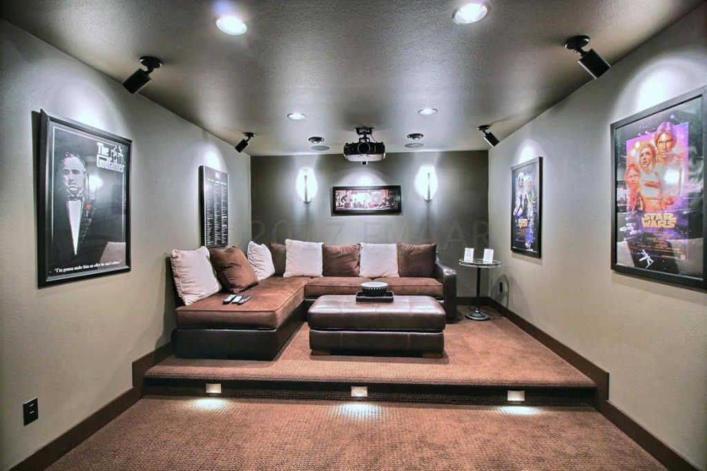 A tiered home theater room featuring brown wall-to-wall carpet installed by Carpet World Fargo, ND