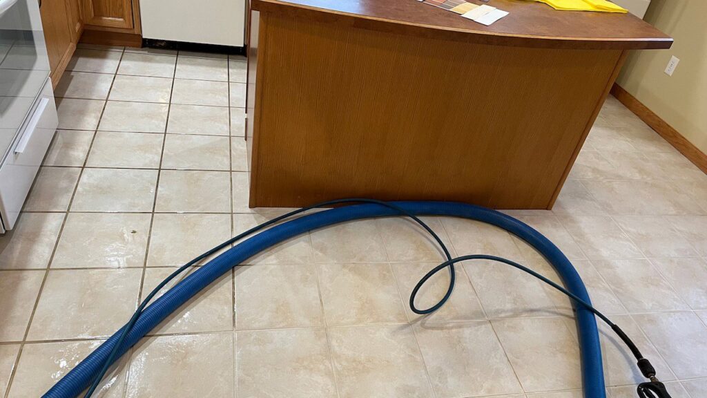A rotary tile and grout cleaning tool in action on a kitchen floor by Jason Lostetter Carpet Cleaning in New Glarus, WI.