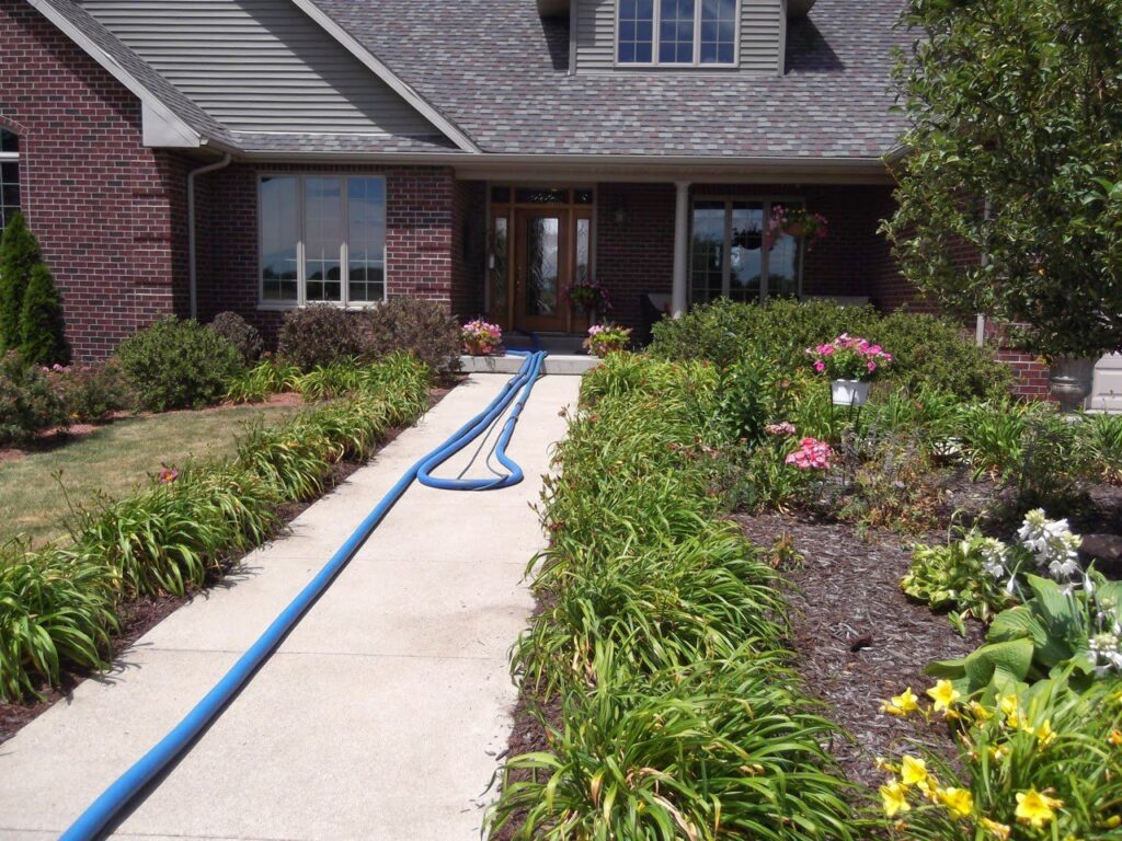 Professional tile floor cleaning equipment and hoses on a kitchen floor by Jason Lostetter Carpet Cleaning in New Glarus, WI.