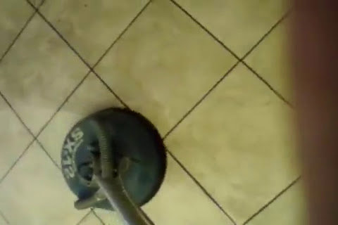 A tile floor being professionally cleaned, showing the cleaning machine and the difference it makes, by A Copesetic Carpet, Upholstery, Tile & Grout Cleaner in Mesa, AZ