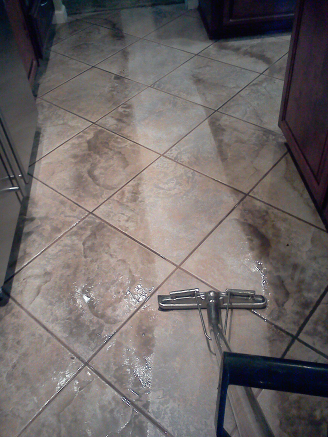 Professional tile floor cleaning in progress by Awesome Carpets in Elk Grove, CA, showing a clear before and after.