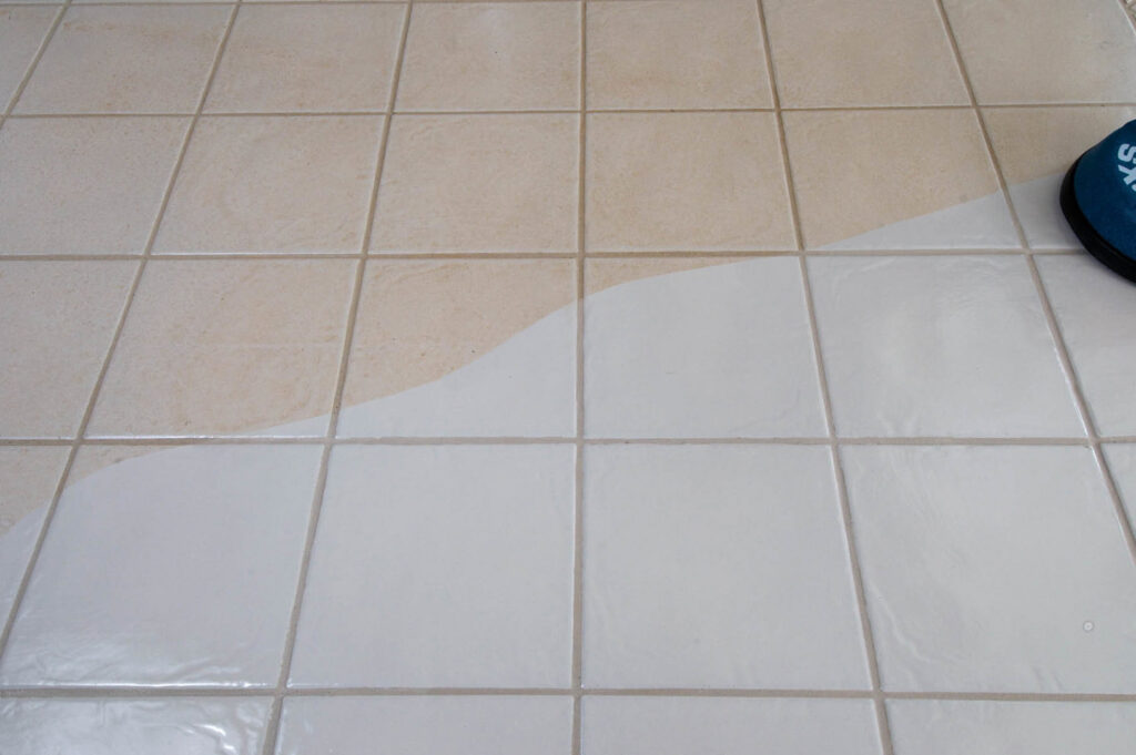Professional tile and grout cleaning in progress, showing a clean section next to a dirty one by Alpine Carpet Care in Medford, OR.