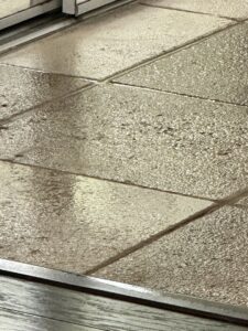 Tile and grout cleaning in progress, showing wet tiles, by Captain Steamer in Cape Coral, FL.