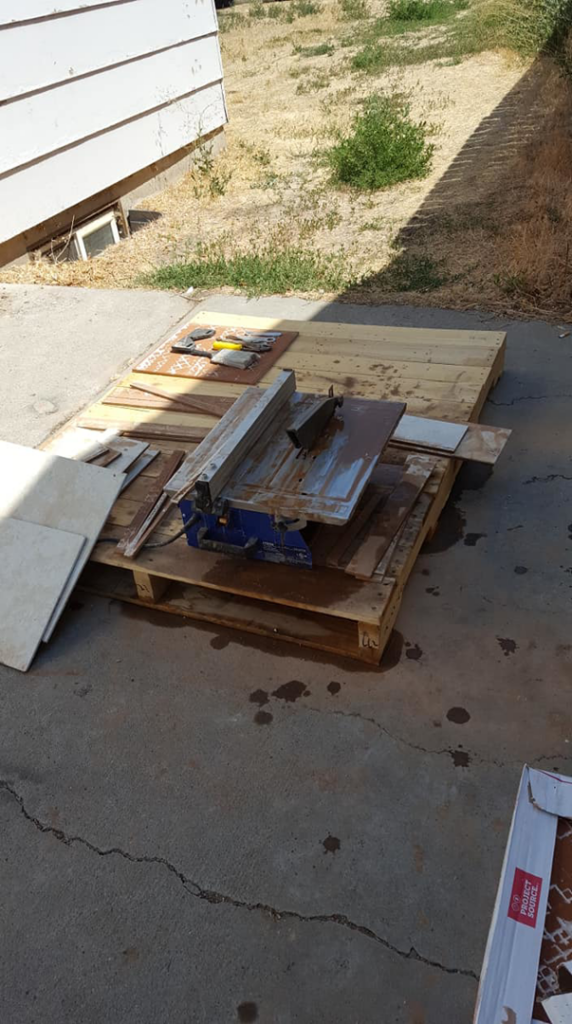 A tile saw and various tiles laid out for an installation project by Clean Time in Lombard, IL.