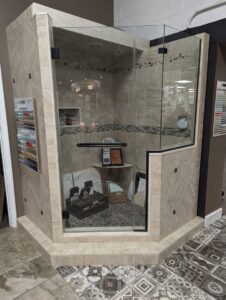 A modern tiled shower enclosure with glass doors, demonstrating tile installation expertise by Petersen's Carpet & Flooring in Frederick, MD