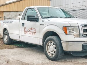 A Toby's Pest Control truck with "Pest Control Professionals Termite Specialists" on the side in Bowling Green, KY.