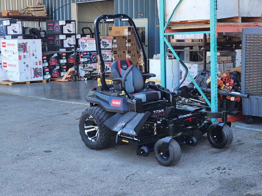 A professional Toro zero-turn mower with an attachment, representing the equipment used by A&B Lawn Services in Baytown, TX.