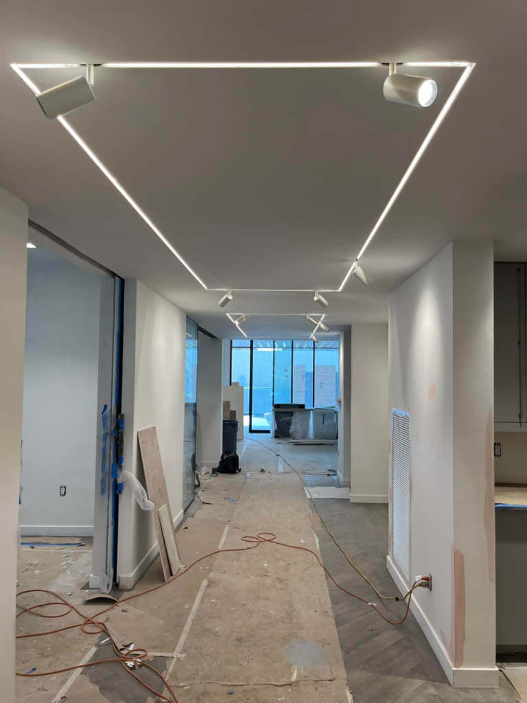 A room under construction with track and linear LED lighting installed in the ceiling by Krajcer Electric in New Orleans, LA
