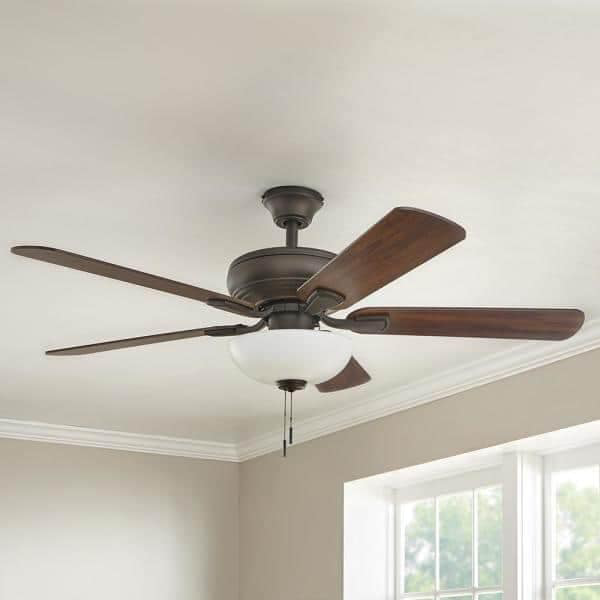A traditional ceiling fan with dark wooden blades and a light kit installed by Jack-O-Lantern Electric in Knoxville, TN.