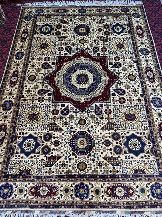 A large, traditional patterned carpet displayed by Mawr Store, a carpet contractor in Chaman-e-Hozori, Kabul, AF