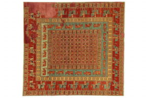A traditional red and green patterned carpet, part of the collection at Woven Legends in Philadelphia, PA.