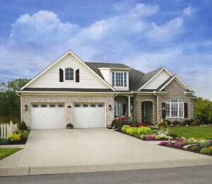 Two traditional white panel garage doors on a classic residential home, showcasing work by Babcock Garage Doors in Vancouver, WA