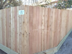 A long section of traditional wood picket fence installed by Castillo Fencing & More in Corpus Christi, TX.