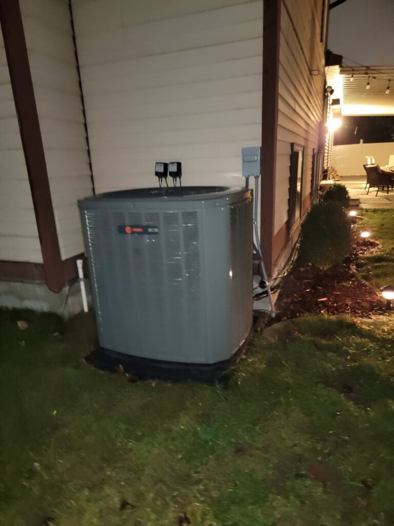 A new Trane AC condenser unit installed outside a home by LUCAS Heating And Air LLC in Salt Lake City, UT.