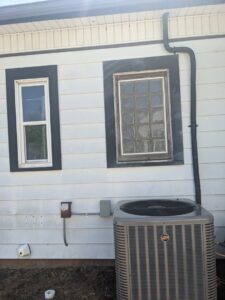 An outdoor Trane air conditioning condenser unit installed by Totality Heating And Cooling in Edmond, OK.