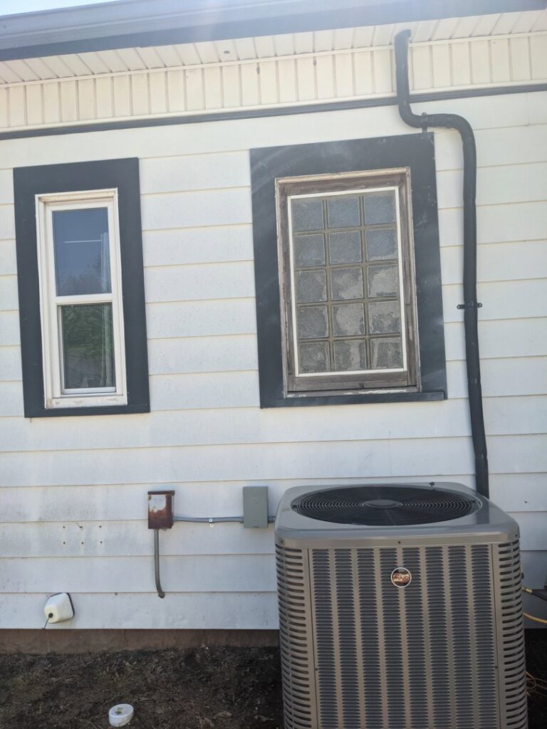 An outdoor Trane air conditioning condenser unit installed by Totality Heating And Cooling in Edmond, OK.