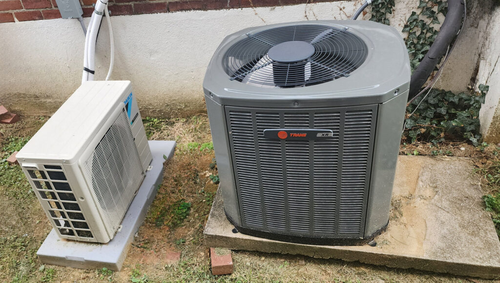 An outdoor Trane air conditioning unit and a Daikin mini-split outdoor unit installed by C&L Heating and Air in Louisville, KY.