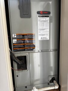 A Trane air handler unit installed in a utility closet, serviced by OnPoint Heating and Air in Commerce City, CO.