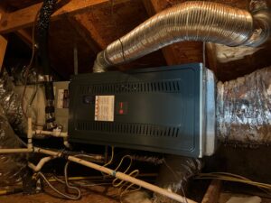 A Trane indoor air handler and furnace unit with ductwork installed in an attic by Fort Worth Air Conditioning Co. Inc. in Fort Worth, TX.