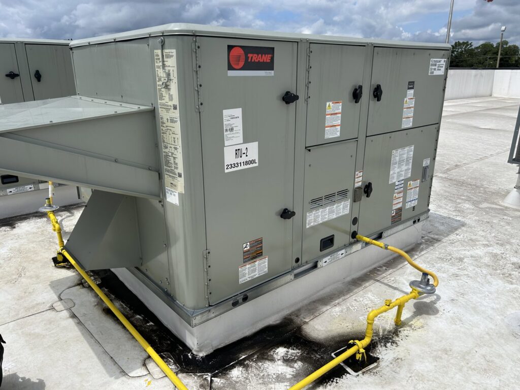 A large Trane commercial rooftop HVAC unit installed on a building by Underwood Heating and Air Conditioning in Phenix City, AL