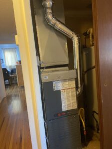 A Trane furnace or air handler unit with ductwork and a water heater installed by Santa Fe Heating & Cooling LLC in Santa Fe, NM.