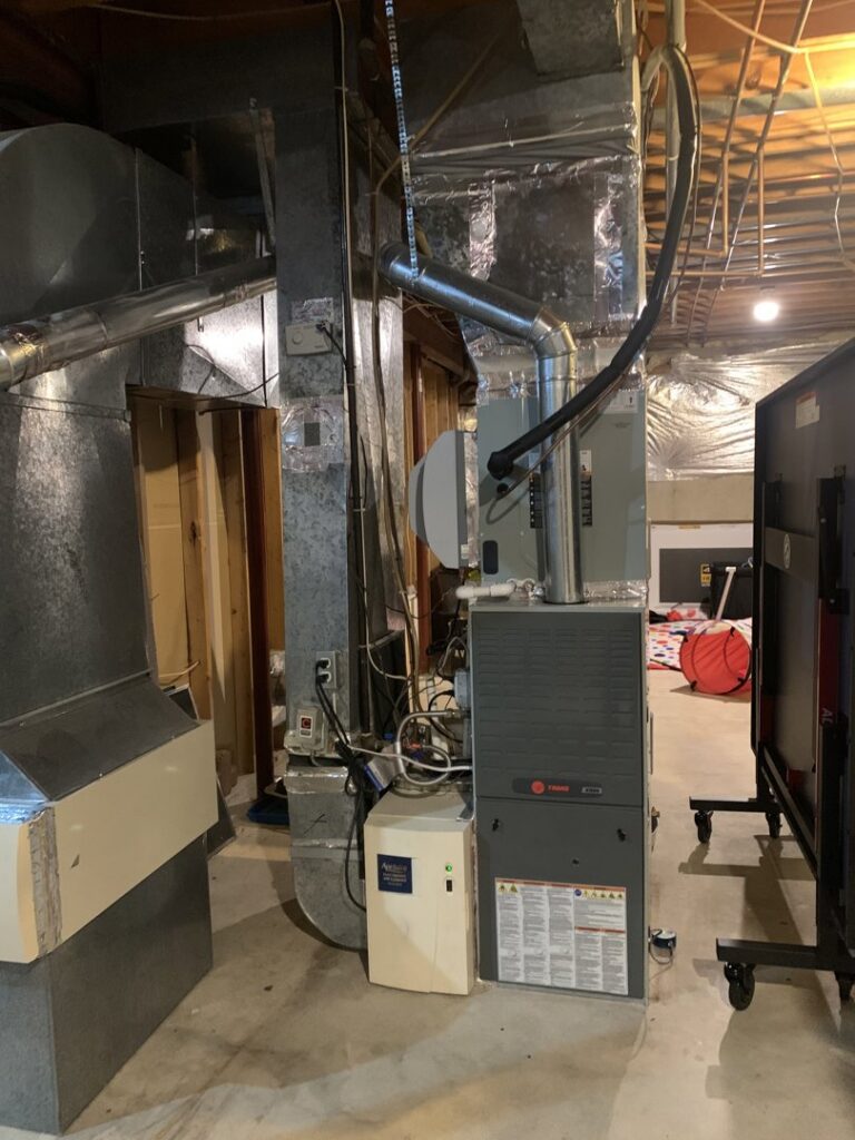 A Trane furnace and air purifier unit with ductwork, part of an HVAC system serviced by AVS Heating and Air Conditioning in Alexandria, VA.