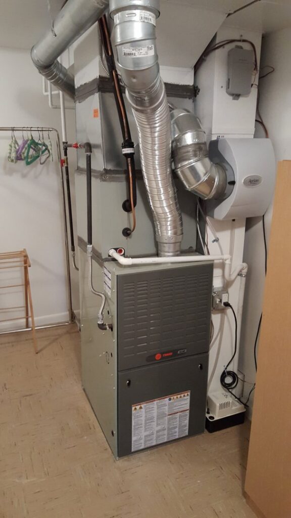 A Trane furnace and air handler with attached ductwork and humidifier installed by Reliable Heating & Cooling LLC in Colorado Springs, CO