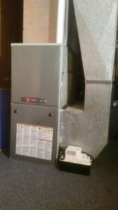 A Trane furnace and ductwork installed in a utility area by Semenik Hvac/r in Spokane, WA.