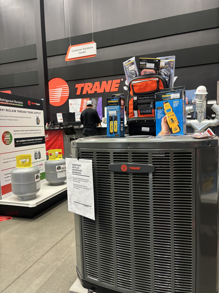 A Trane HVAC condenser unit and tools displayed, representing services by JLS Mechanical HVAC, LLC in Smyrna, TN.