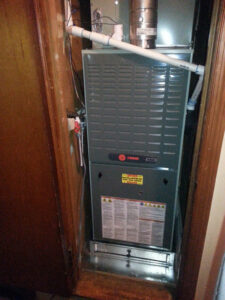A Trane HVAC furnace and air handler unit installed in a closet by C&K Air and Heating, Inc. in Olive Branch, MS.