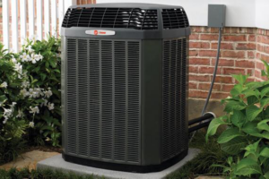 A newly installed Trane HVAC outdoor unit next to a brick house, serviced by L.N.P Heating & Cooling in Columbus, OH