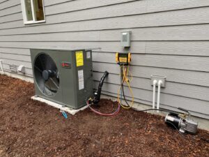 A Trane HVAC outdoor unit being installed or serviced with gauges and vacuum pump by Climate Control Experts HVAC LLC in Federal Way, WA