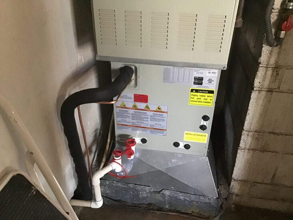 An indoor Trane HVAC unit installation with visible piping by Southern Oregon Heating & Air Conditioning in Medford, OR