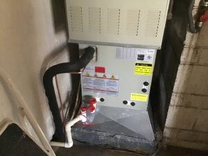An indoor Trane HVAC unit installation with visible piping by Southern Oregon Heating & Air Conditioning in Medford, OR
