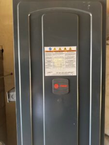 A close-up of the front panel of a Trane indoor HVAC unit, installed by Southern Oregon Heating & Air Conditioning in Medford, OR