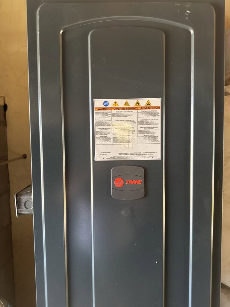 A close-up of the front panel of a Trane indoor HVAC unit, installed by Southern Oregon Heating & Air Conditioning in Medford, OR