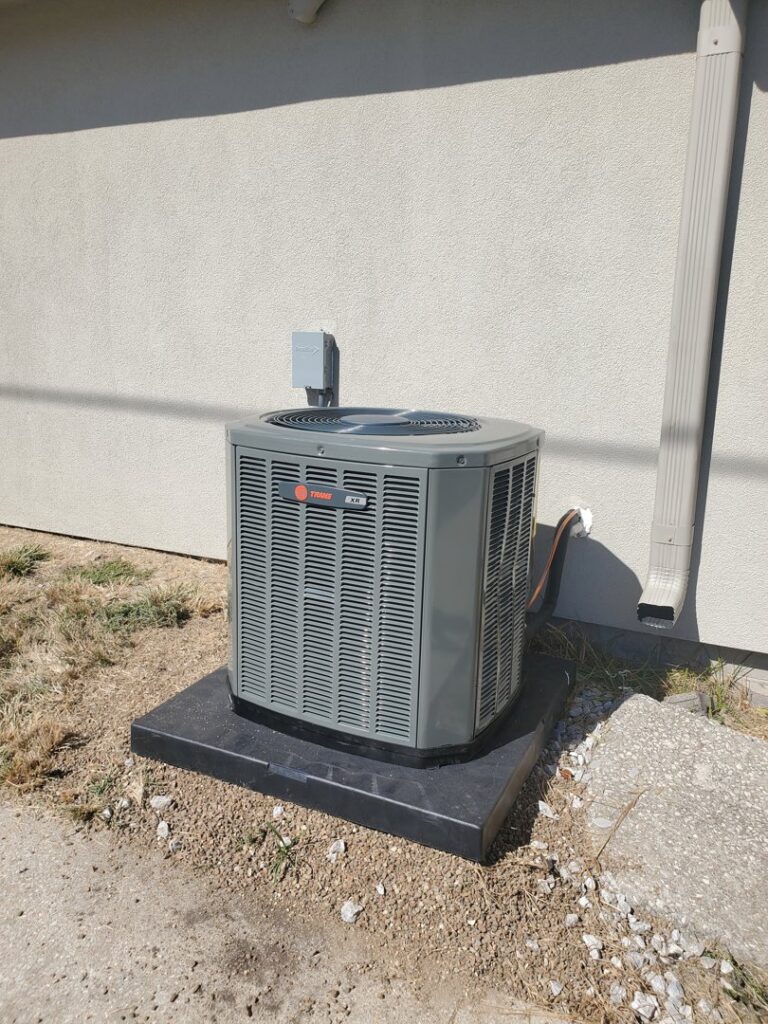A new Trane outdoor air conditioning unit installed by Cloud Heating & Air Conditioning in Lawrence, KS.