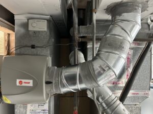 A Trane whole-house humidifier installed with ductwork by Sandys Heating & Air in Papillion, NE.